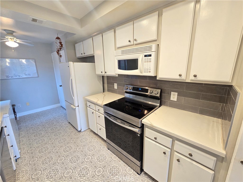 8828 Pershing Drive, Unit 121 Playa del Rey, CA 90293 - Photo 3 of 54 a kitchen with a stove microwave and refrigerator