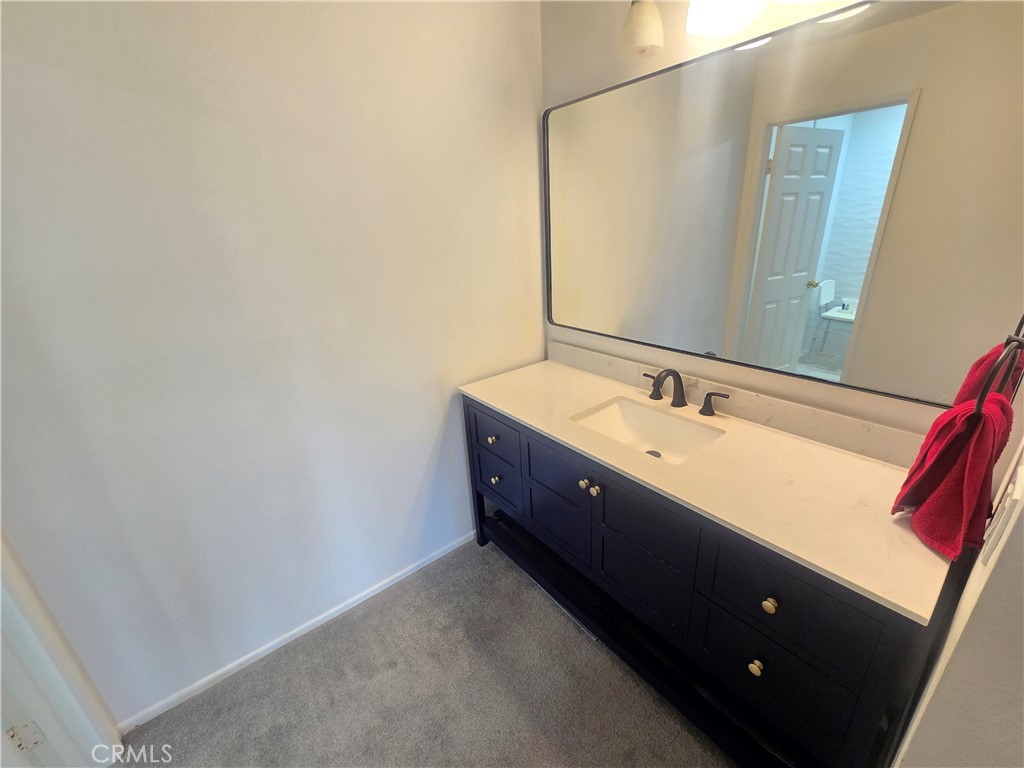 8828 Pershing Drive, Unit 121 Playa del Rey, CA 90293 - Photo 31 of 54 a spacious bathroom with a double vanity sink and a mirror