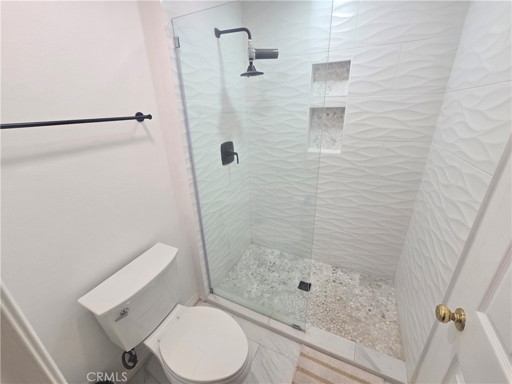 8828 Pershing Drive, Unit 121 Playa del Rey, CA 90293 - Photo 33 of 54 a bathroom with a shower and toilet