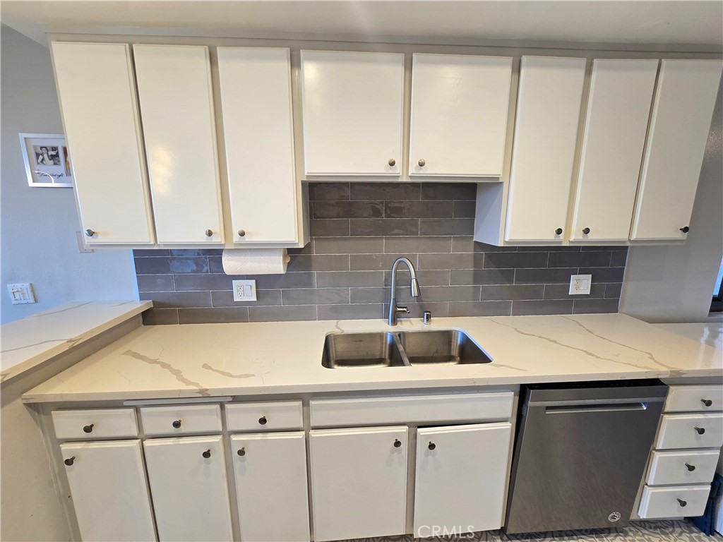 8828 Pershing Drive, Unit 121 Playa del Rey, CA 90293 - Photo 5 of 54 a kitchen with a sink and cabinets