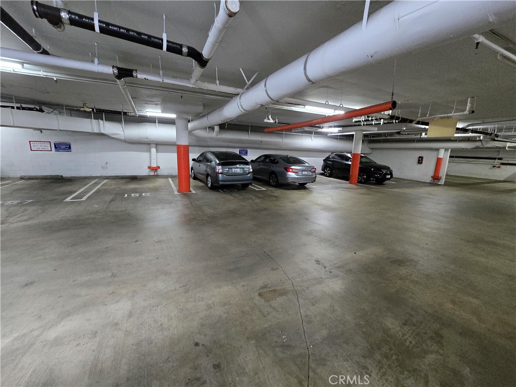 8828 Pershing Drive, Unit 121 Playa del Rey, CA 90293 - Photo 51 of 54 a view of parking garage with cars and a garage