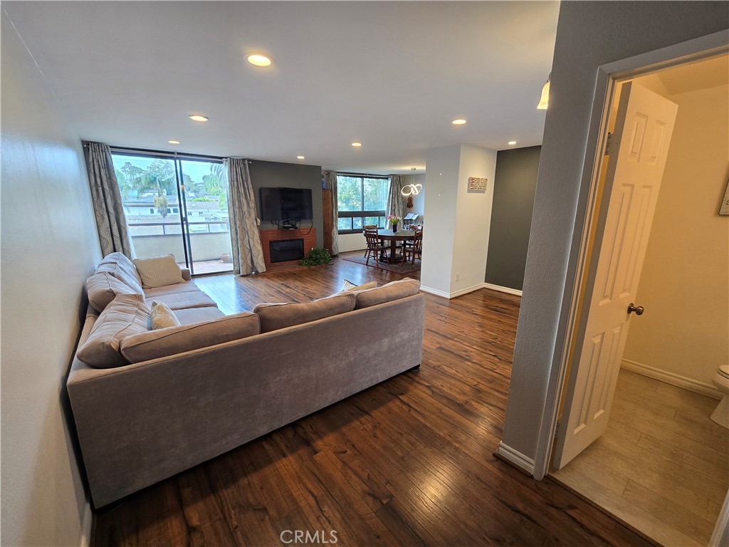 8828 Pershing Drive, Unit 121 Playa del Rey, CA 90293 - Photo 7 of 54 a living room with furniture floor to ceiling window and wooden floor