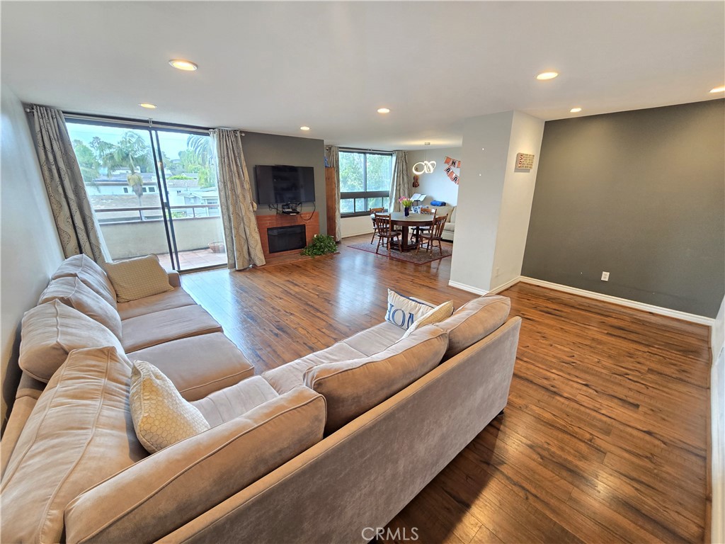 8828 Pershing Drive, Unit 121 Playa del Rey, CA 90293 - Photo 9 of 54 a living room with furniture and a flat screen tv