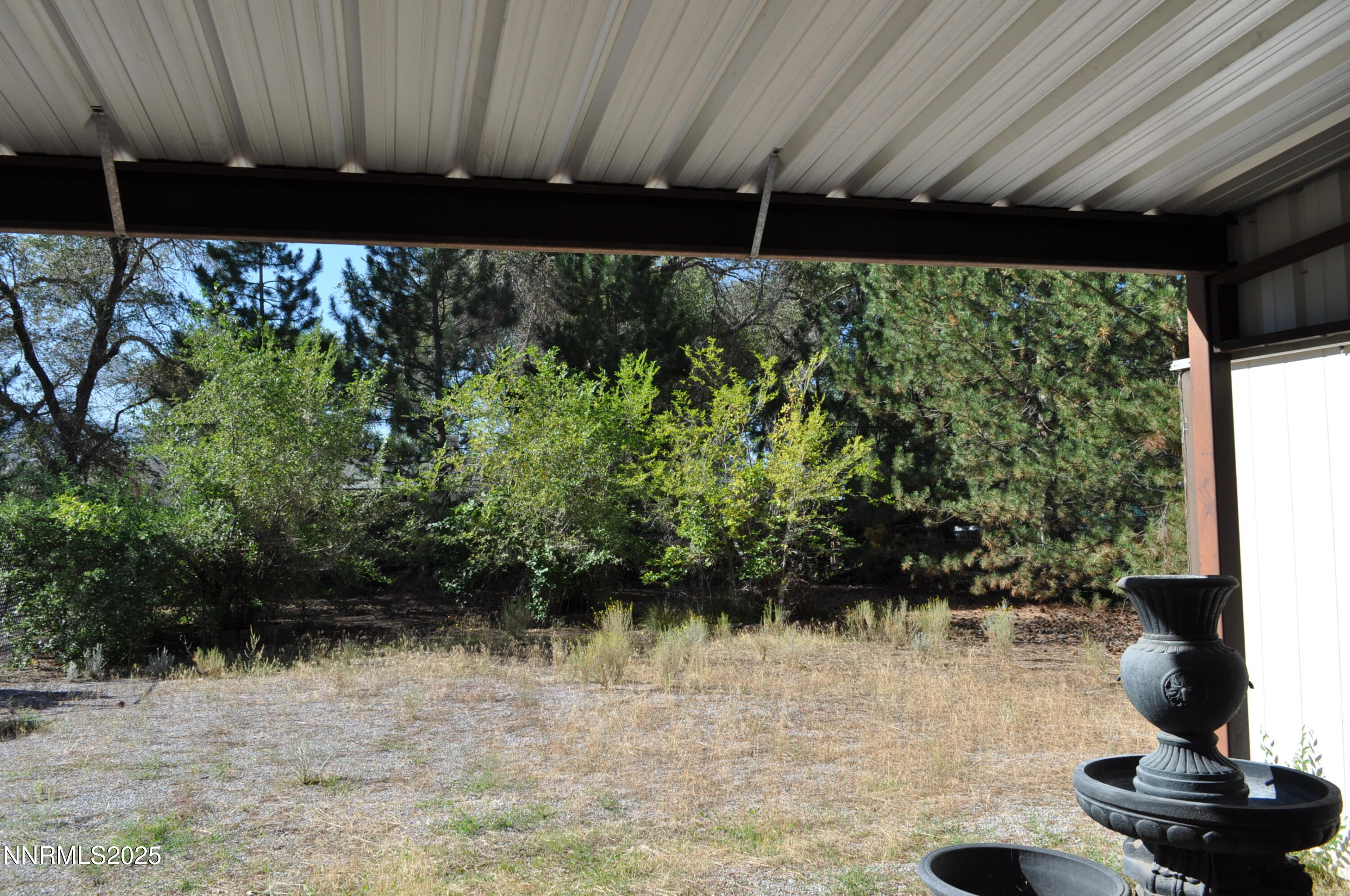 17940 Cold Springs Drive Reno, NV 89508 - Photo 19 of 21 a backyard of a house with lots of green space and a fountain