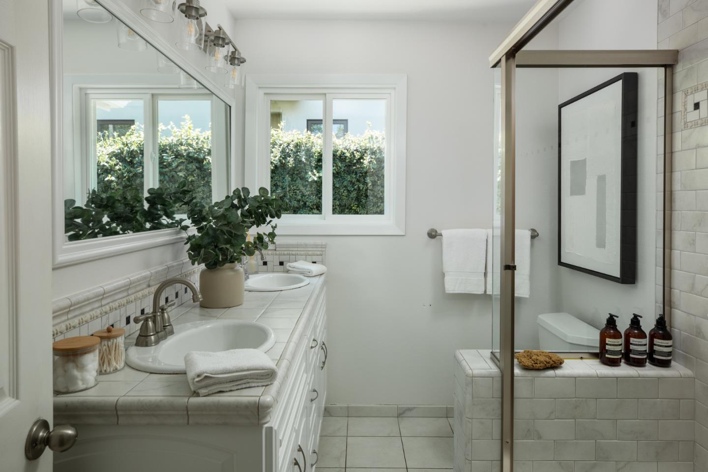 115 Walnut Street Menlo Park, CA 94025 - Photo 6 of 12 a bathroom with a granite countertop sink a mirror and a shower