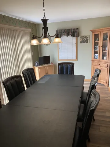 a living room with furniture a fireplace and a chandelier