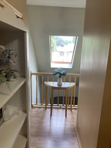 a view of a livingroom with furniture window and wooden floor