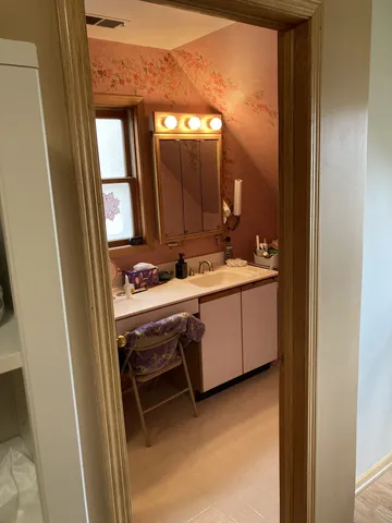 a bathroom with a sink a mirror and a vanity