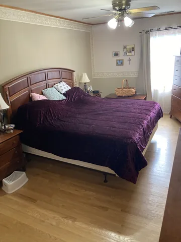 a bedroom with a bed and a mirror