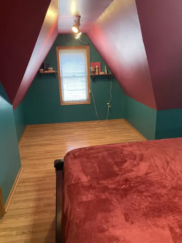 a bedroom with a bed dresser and a window