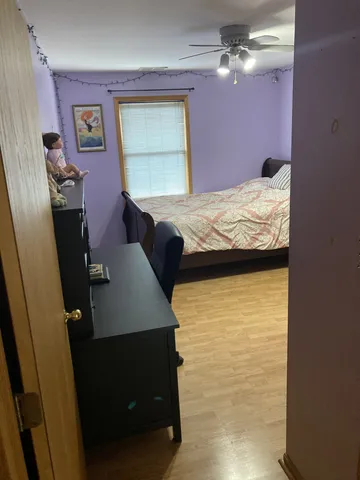 a bedroom with a bed and chandelier