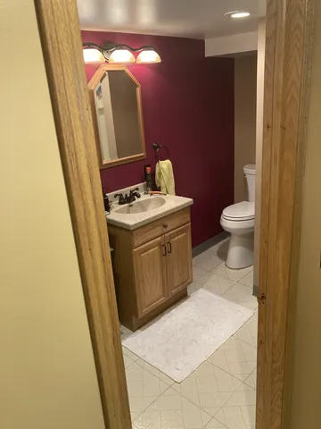 a bathroom with a sink toilet and a mirror