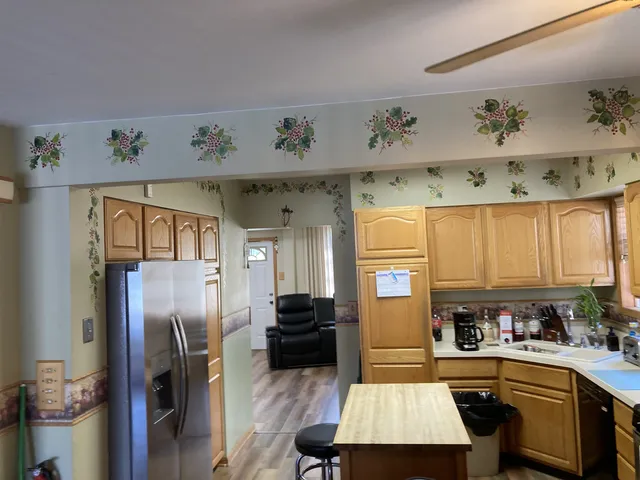 a kitchen with a refrigerator a sink and cabinets