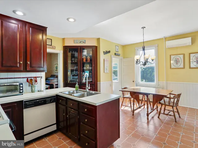 a kitchen with a cabinets counter top space a sink stainless steel appliances and a window