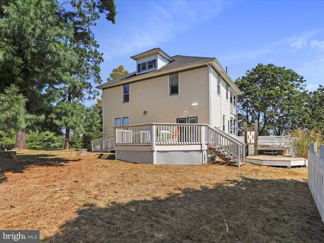 a view of a house with a yard covered in snow