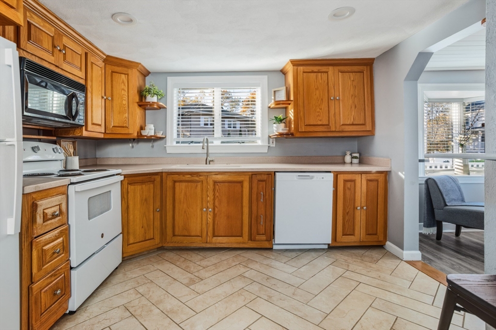 22 Laconia Avenue Saugus, MA 01906 - Photo 12 of 36 a kitchen with stainless steel appliances granite countertop a stove a sink and a microwave