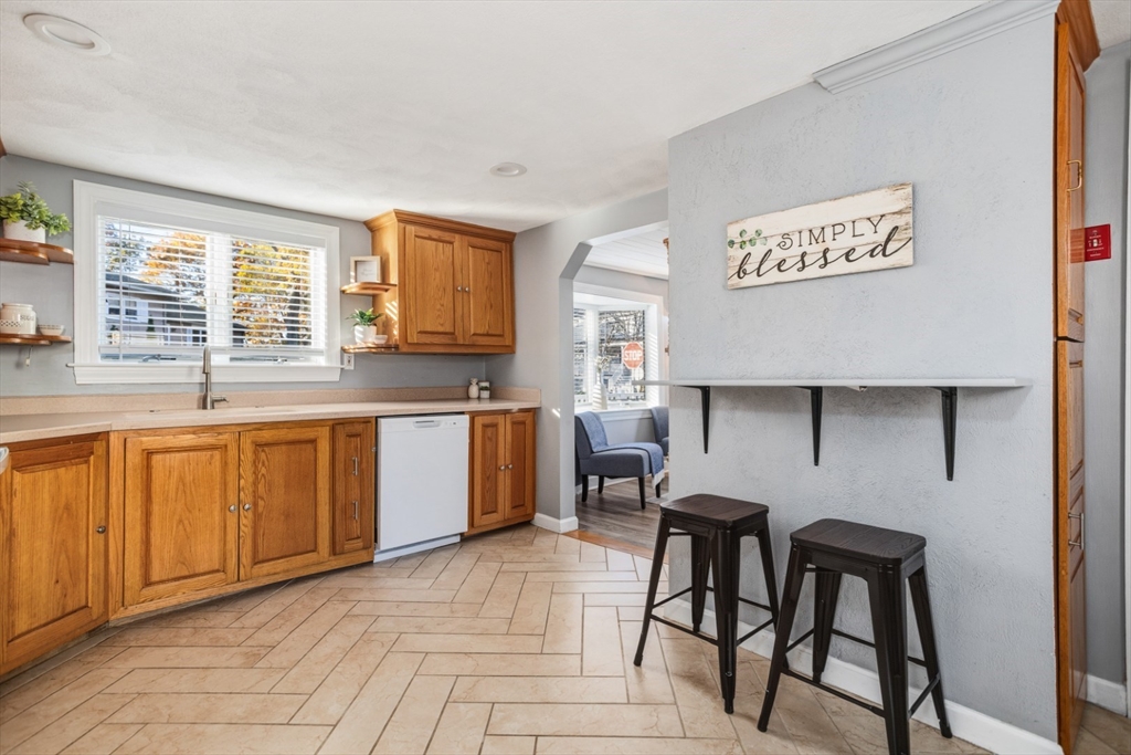 22 Laconia Avenue Saugus, MA 01906 - Photo 13 of 36 a kitchen with stainless steel appliances granite countertop a stove a sink dishwasher and cabinets