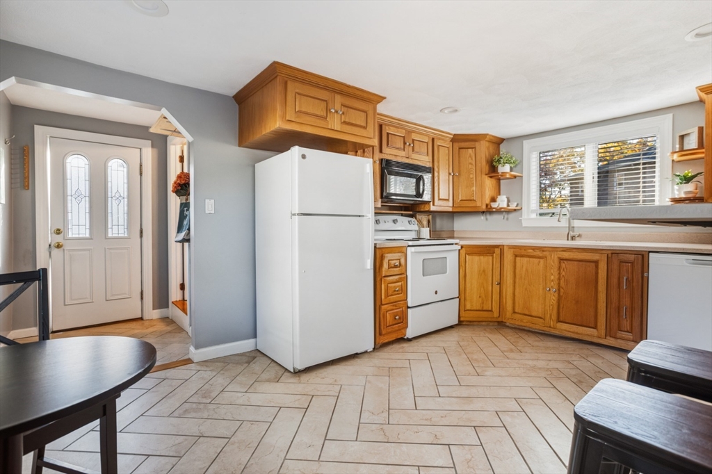 22 Laconia Avenue Saugus, MA 01906 - Photo 16 of 36 a kitchen with stainless steel appliances granite countertop a sink stove and refrigerator