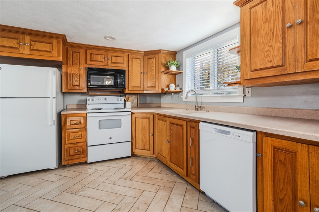 22 Laconia Avenue Saugus, MA 01906 - Photo 10 of 36 a kitchen with a stove top oven sink and cabinets