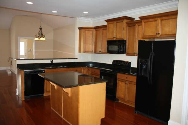 1024 Rochelle Avenue Thompson's Station, TN 37179 - Photo 3 of 20 This well thought out kitchen opens to the entertaining areas. The working island has it's own GRANITE breakfast bar, maple cabinets and stunning granite countertops.