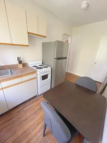a kitchen with a sink appliances and cabinets