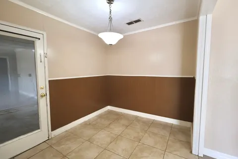 a view of storage and utility room with a window