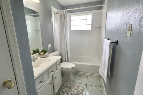 an empty room with a chandelier fan