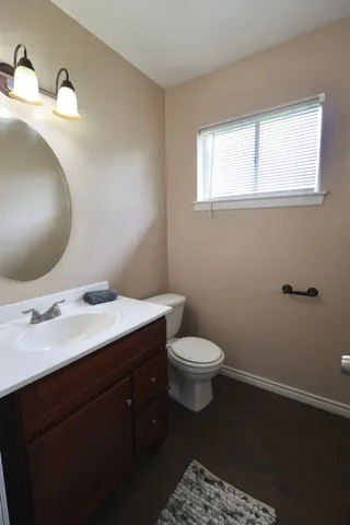 an empty room with wooden floor and ceiling fan
