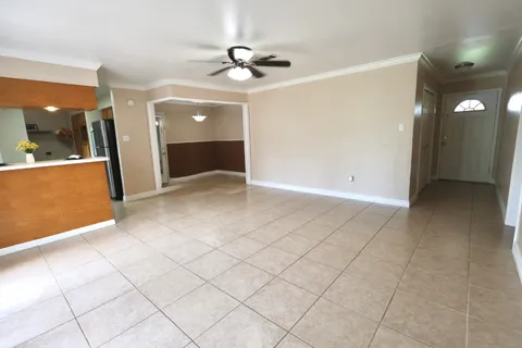 a view of a livingroom with a furniture and chandelier fan
