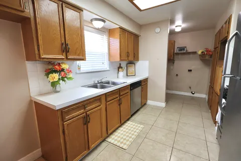 an empty room with a ceiling fan and carpet