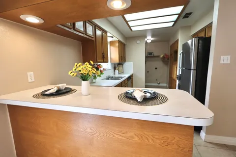 a kitchen with a sink cabinets and window