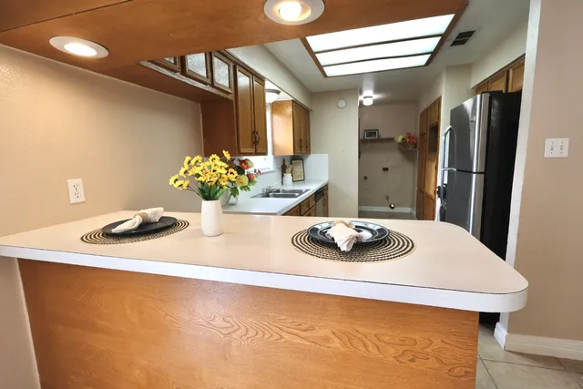 a kitchen with a sink cabinets and window