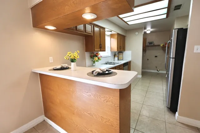 a kitchen with a sink window and cabinets