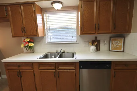 a kitchen with a sink and a mirror
