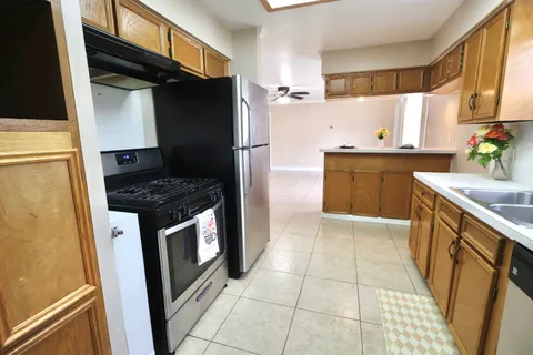 a kitchen with a sink cabinets and window