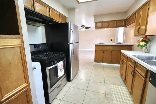 a kitchen with a sink cabinets and window