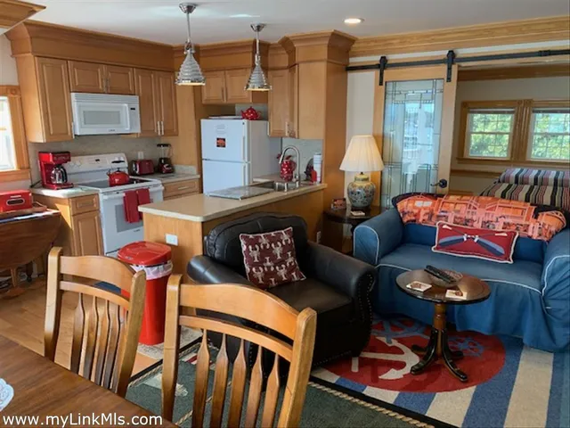 a living room with furniture a window and a chandelier