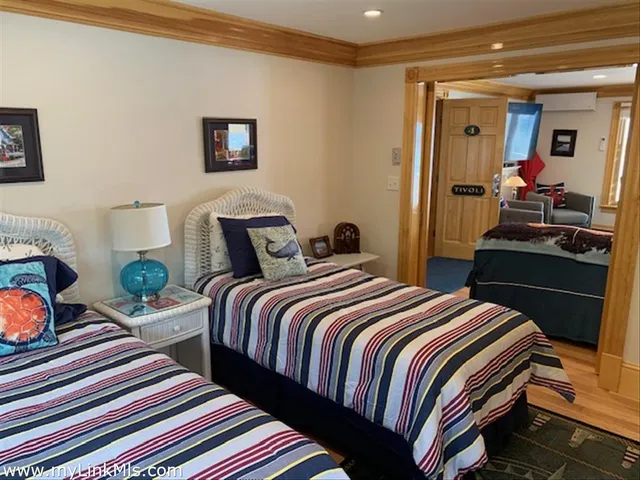 a bedroom with bed and wooden floor