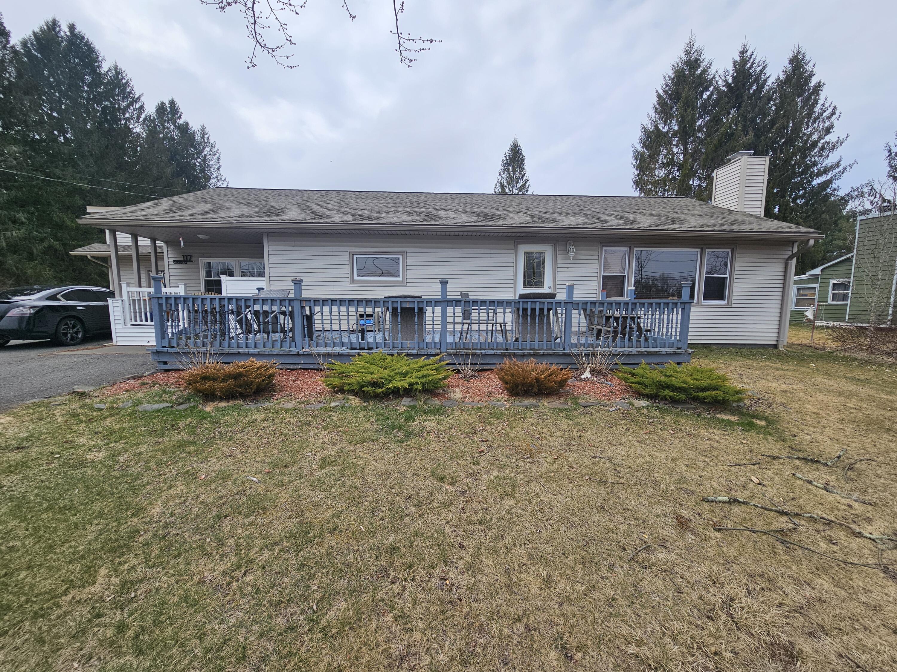 117 Cross Street Pocono Lake, PA 18347 - Photo 1 of 26 a view of a house with a patio and a yard