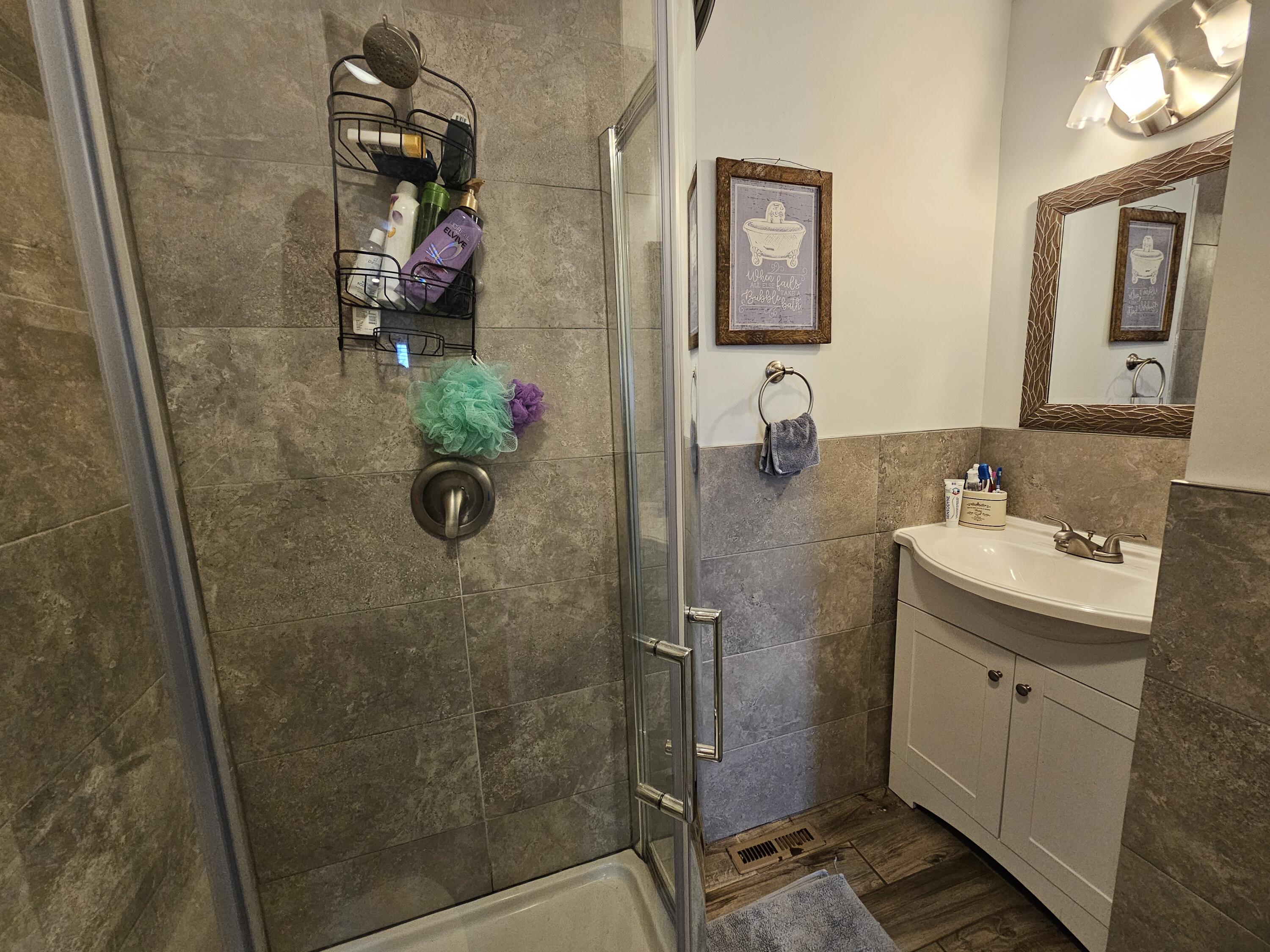 117 Cross Street Pocono Lake, PA 18347 - Photo 20 of 26 a bathroom with a granite countertop shower sink and mirror