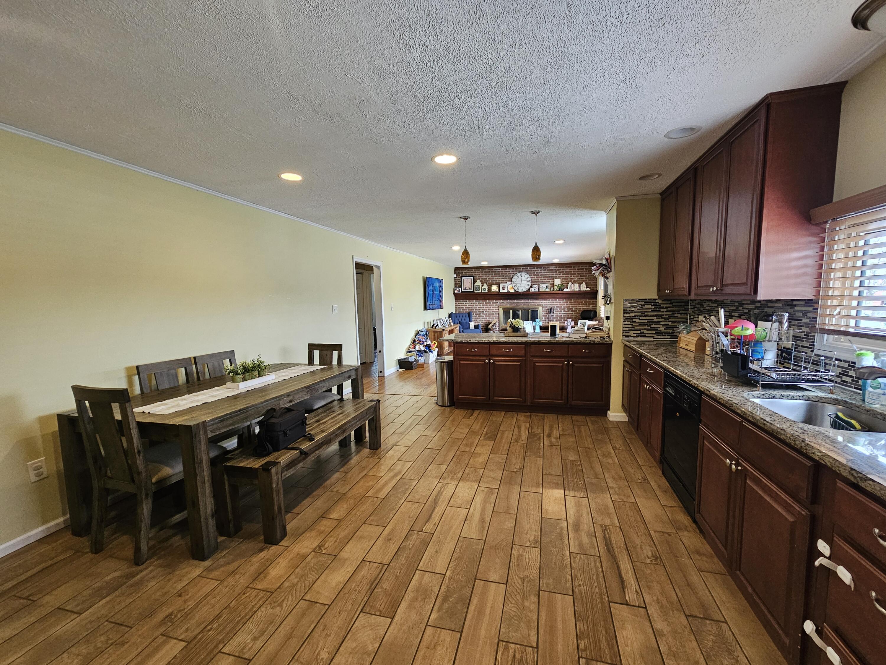 117 Cross Street Pocono Lake, PA 18347 - Photo 4 of 26 a kitchen with stainless steel appliances wooden floors and wooden cabinets