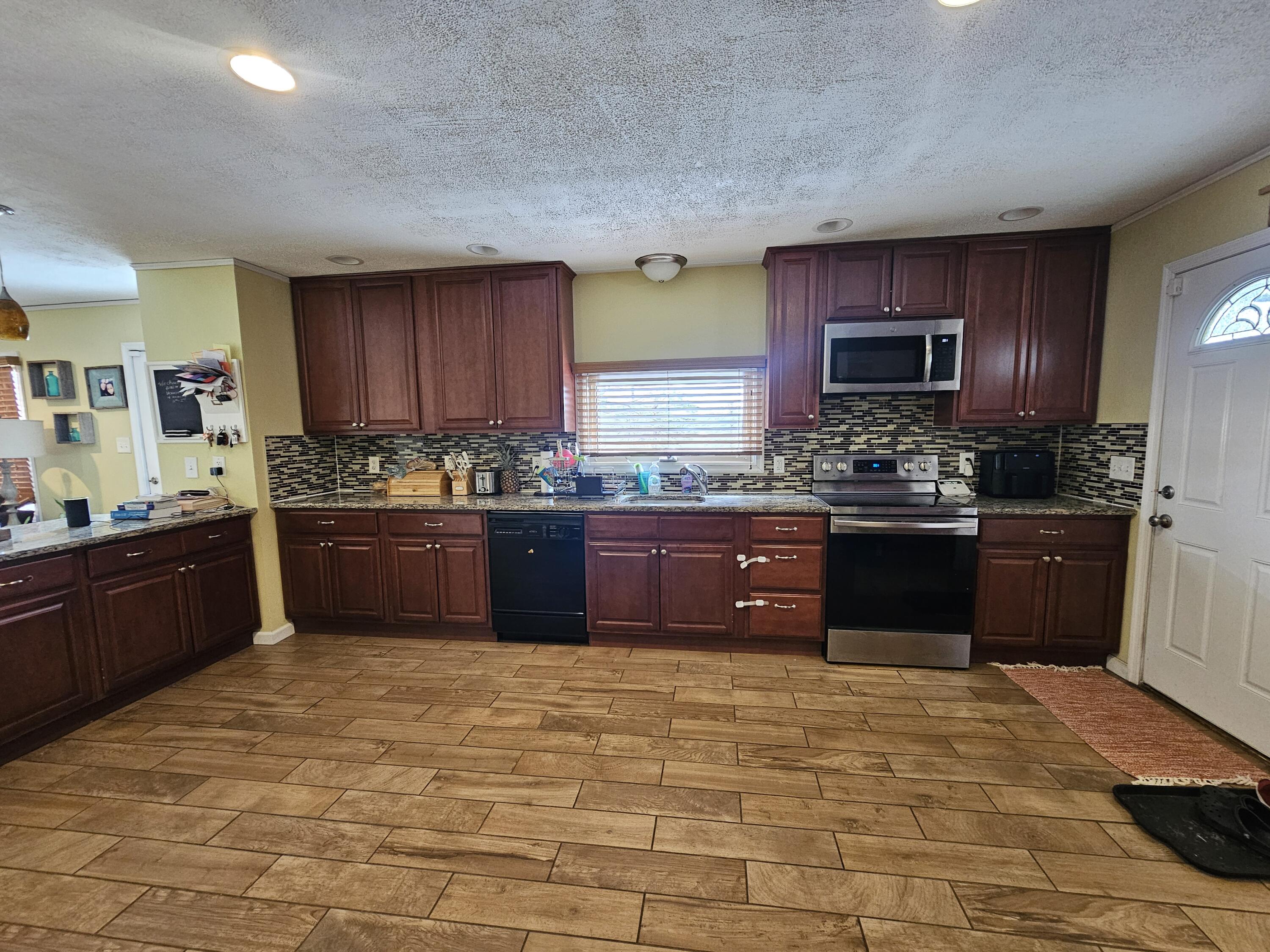 117 Cross Street Pocono Lake, PA 18347 - Photo 5 of 26 a kitchen with stainless steel appliances granite countertop a stove sink and cabinets
