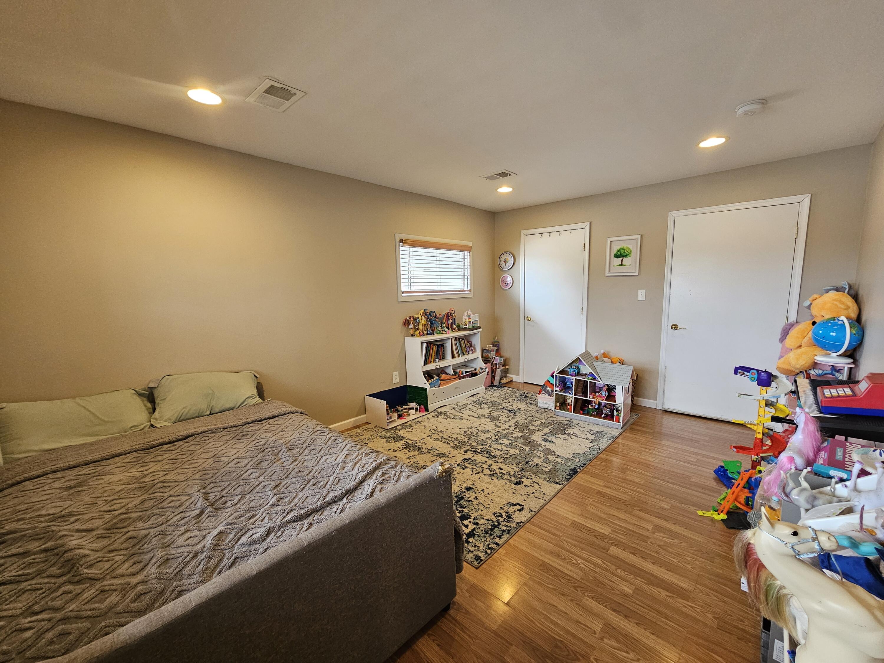 117 Cross Street Pocono Lake, PA 18347 - Photo 10 of 26 a bedroom with a bed and wooden floor