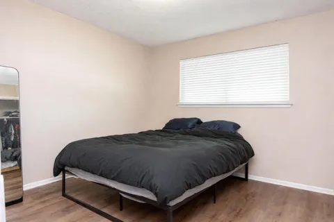 a bedroom with a bed and window