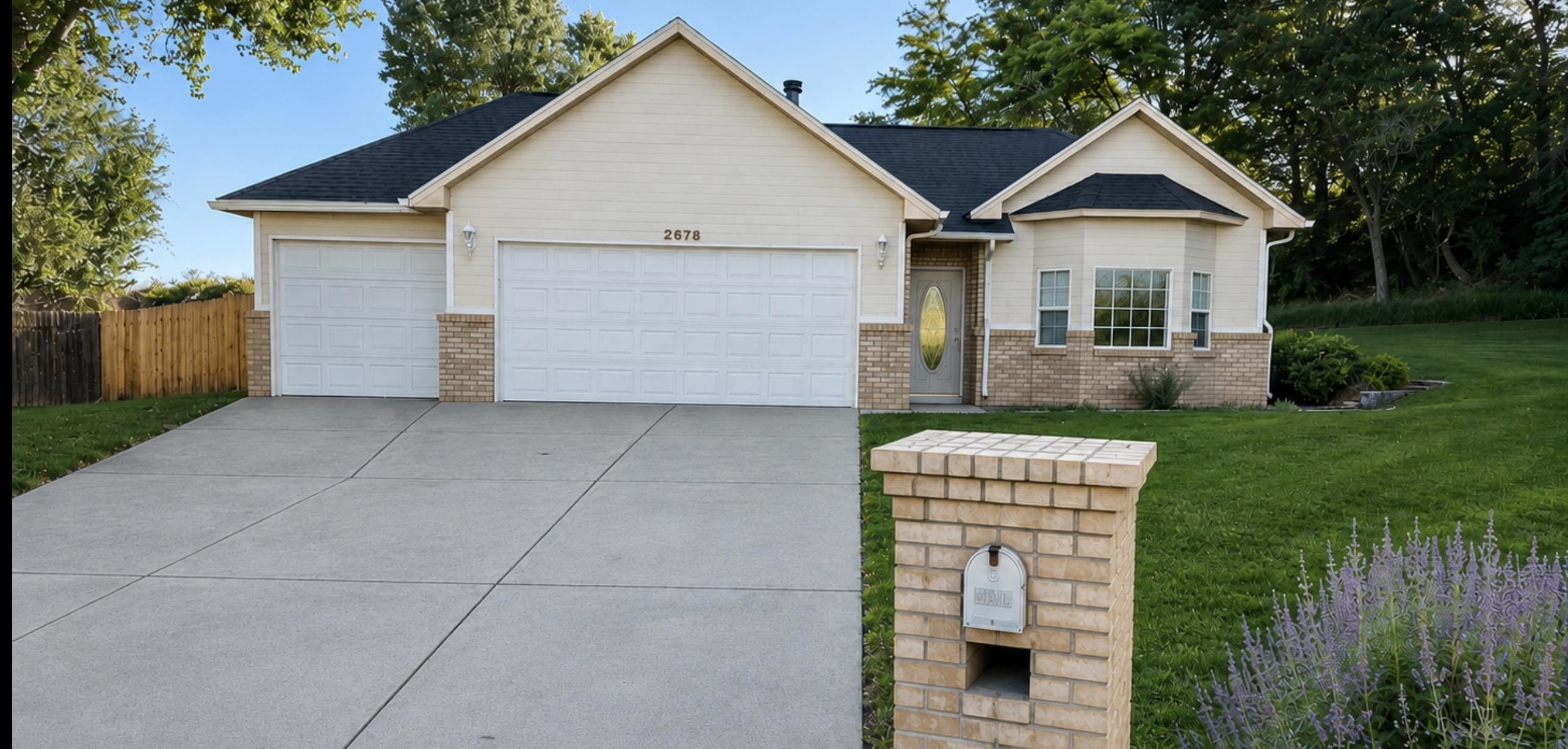 2678 Cambridge Road Grand Junction, CO 81506 - Photo 1 of 32 a front view of a house with a yard and garage