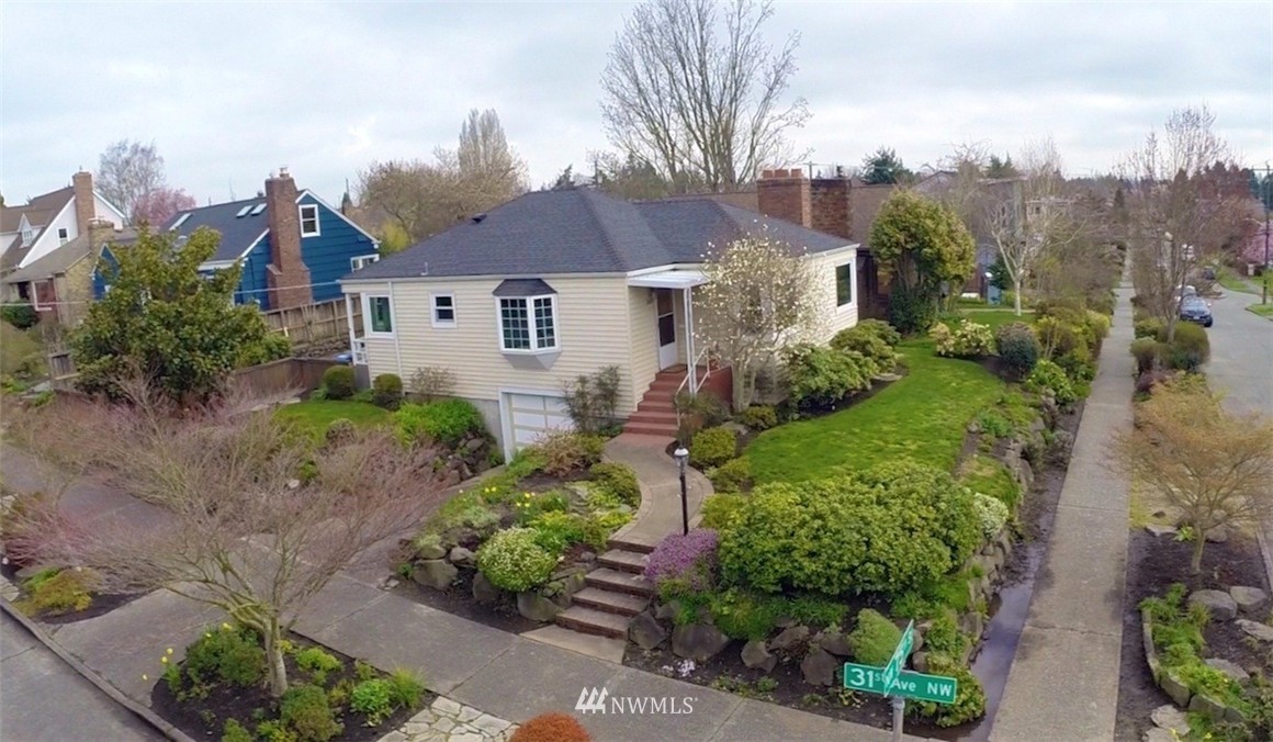3020 Northwest 75th Street Seattle, WA 98117 - Photo 2 of 22 a front view of a house with a yard and fountain