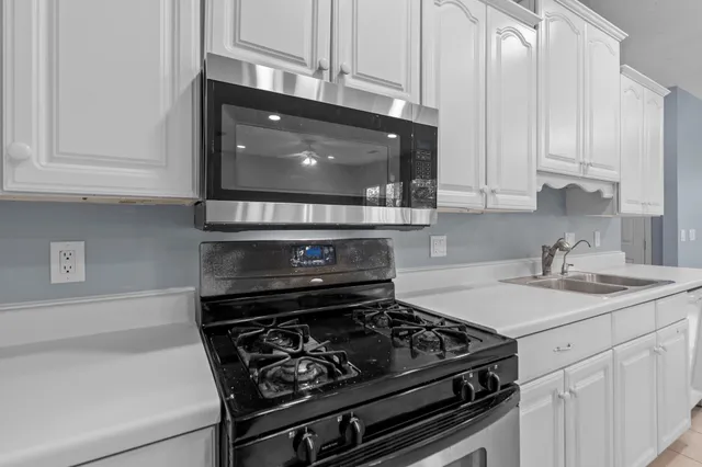 a kitchen with stainless steel appliances granite countertop a refrigerator sink and cabinets