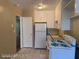 a kitchen with a refrigerator and a stove