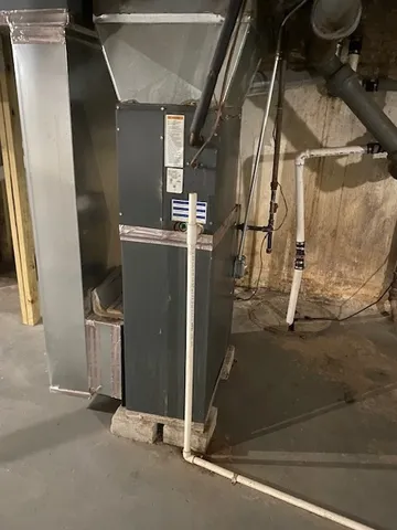 an aerial view of a house with a yard and large trees