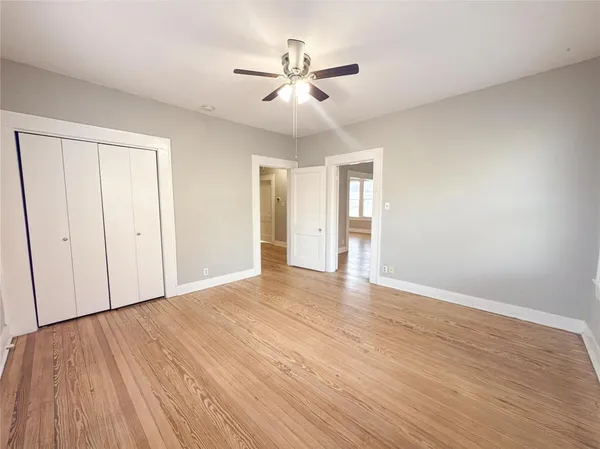 a view of an empty room with wooden floor